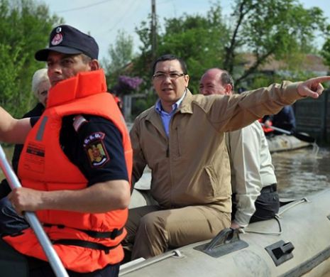 Ponta, într-o barcă pneumatică şi împins de pompieri, la Teleorman. Prinţii William şi Harry cărau saci cu nisip, în mijlocul inundaţiilor din Marea Britanie | GALERIE FOTO