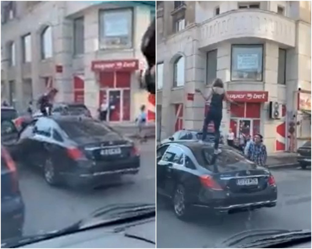 Show la semafor în centrul Bucureștiului. O femeie s-a urcat în picioare pe capota unei mașini de lux. VIDEO